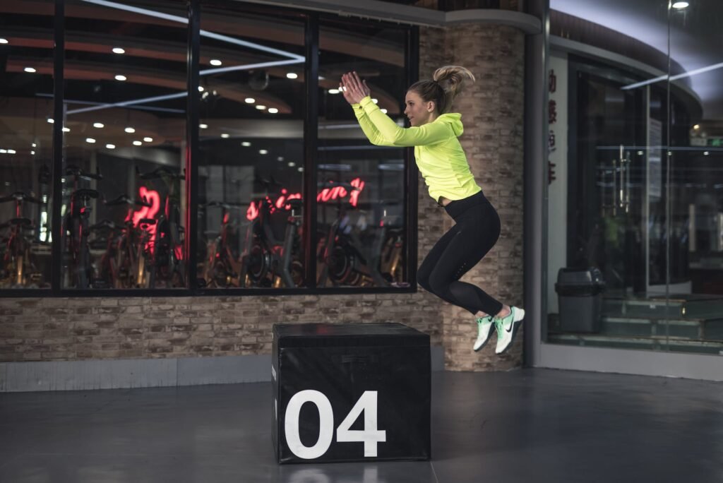 photo of woman jumping on box