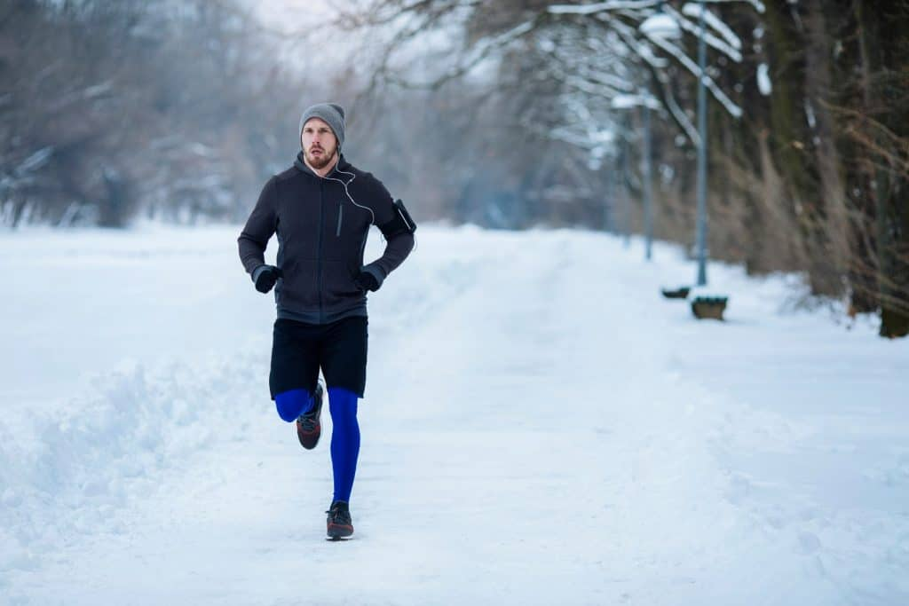 Un homme court dans la neige