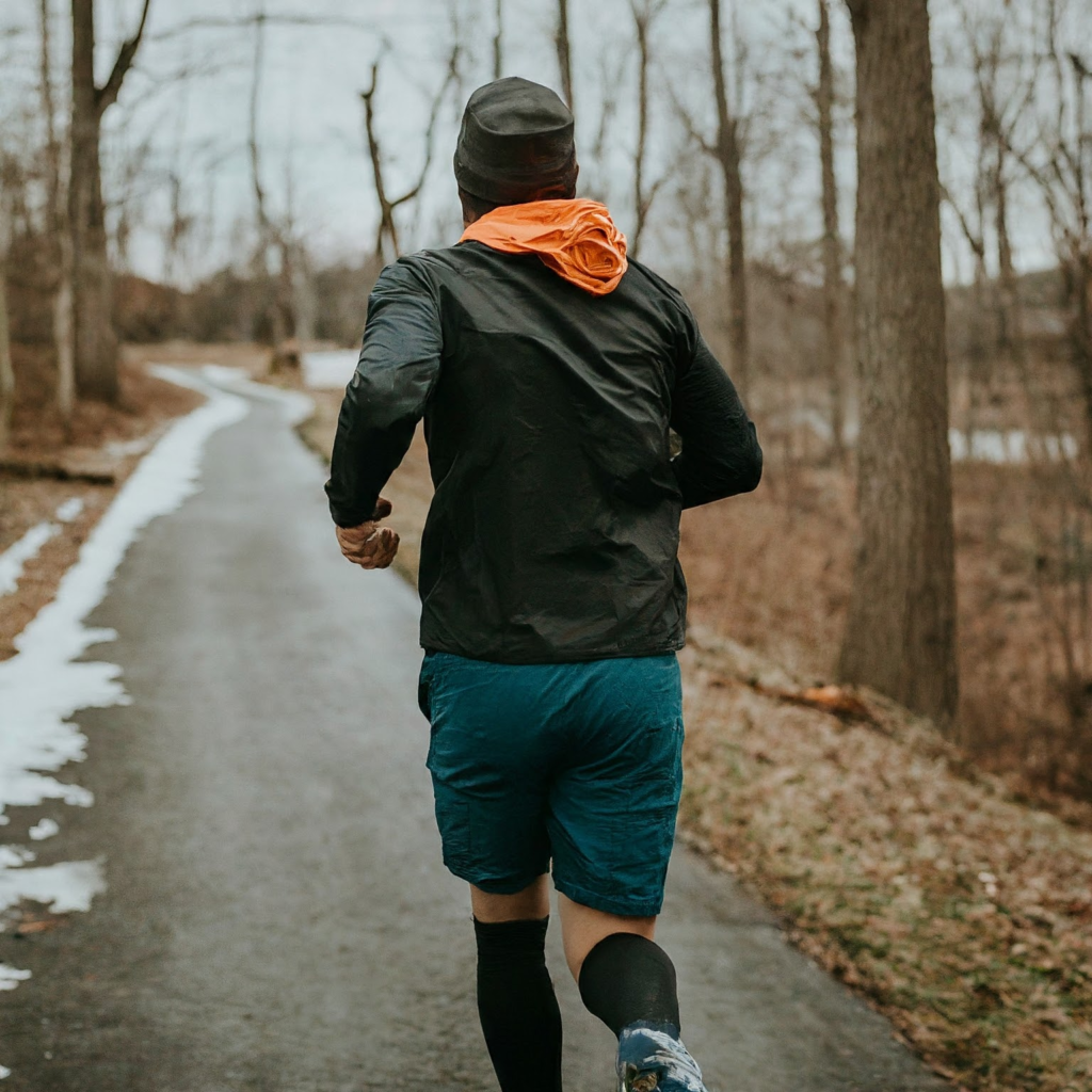 Un coureur court sur la route au printemps